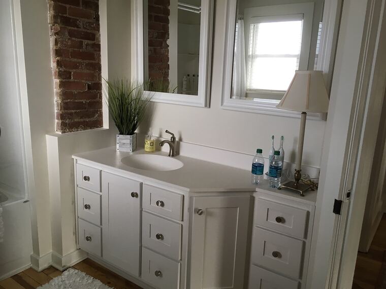 Bathroom vanity with brick accent wall