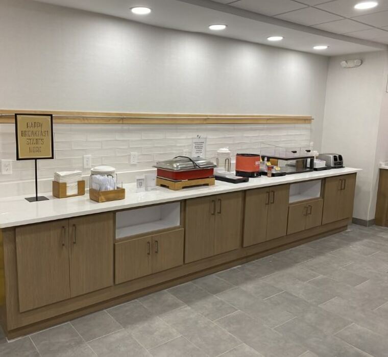 Breakfast buffet counter with a quartz top and wood ledge