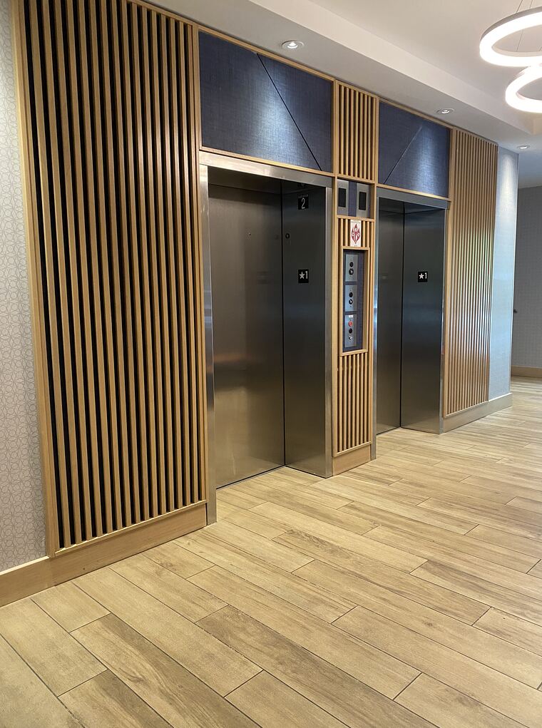 Commercial elevator lobby with wood slat walls