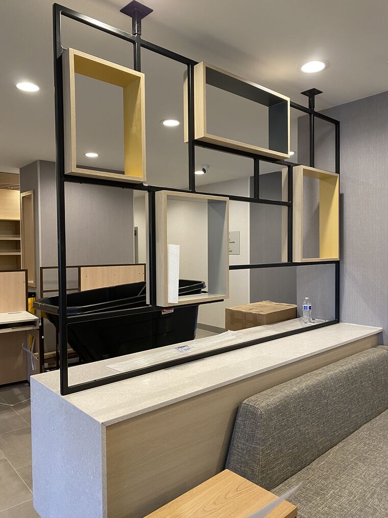 Commercial lounge divider with framed shelving