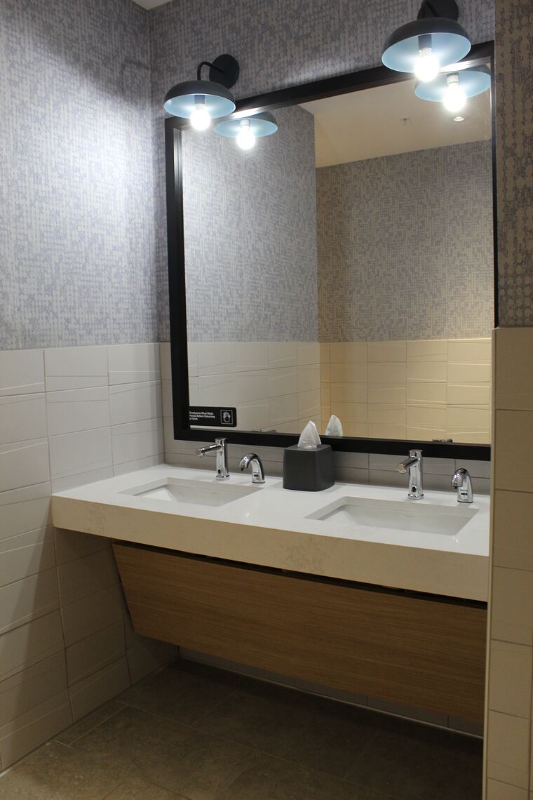 Restroom vanity with trough sinks