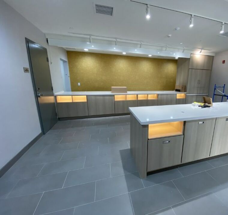 Commercial servery with a long cabinet run and a matching island