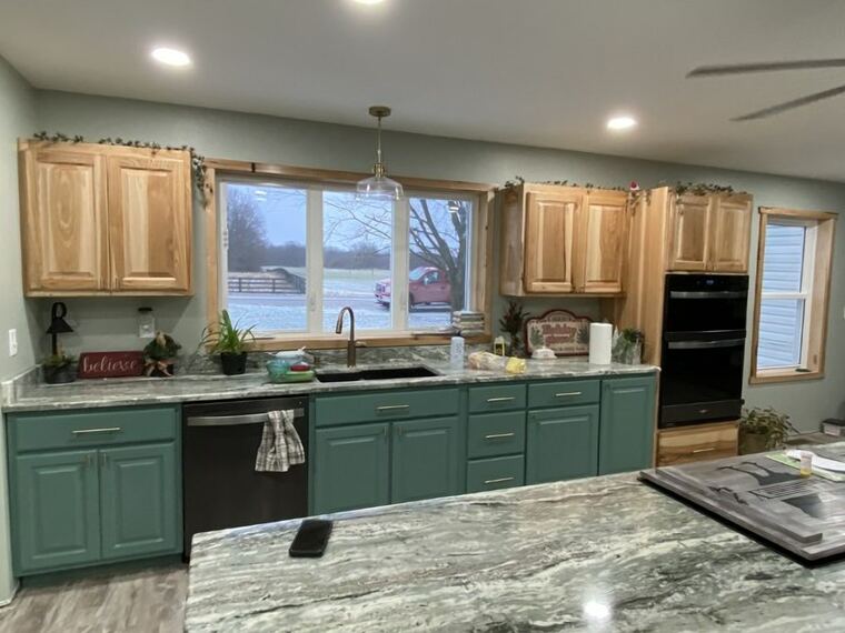 Two-tone kitchen with hickory upper cabinets and painted green bases
