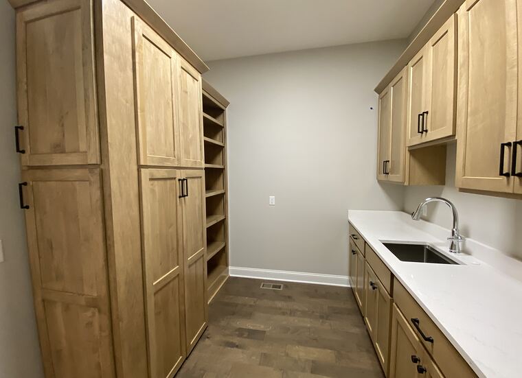 Maple pantry cabinets with a sink run and open shelving
