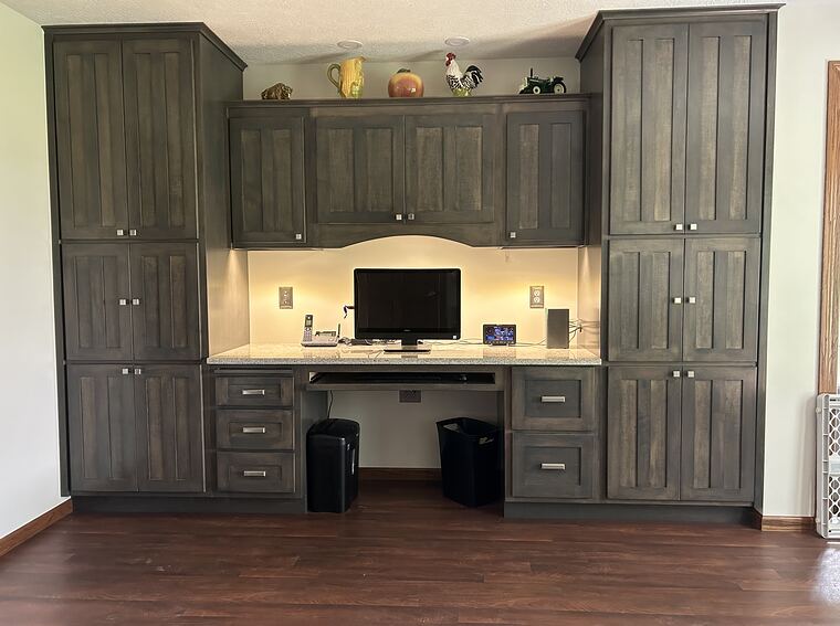 Home office with built-in desk and cabinets