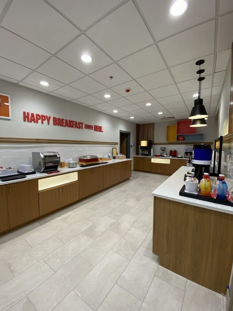 Hotel breakfast bar with oak casework and a quartz serving counter