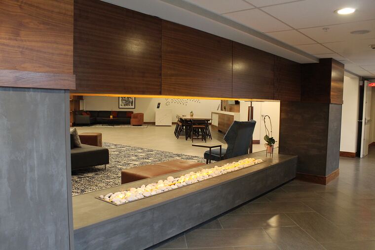 Hotel lobby with fireplace and wood feature wall