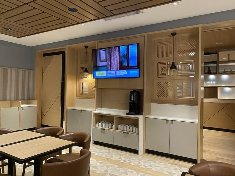 Lobby cabinetry with laser-cut screen panels and a beverage station