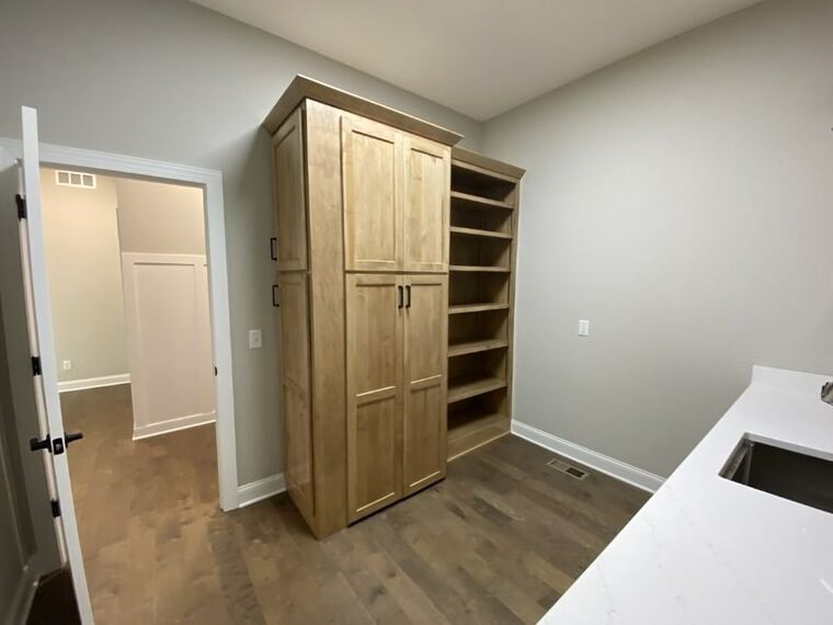Maple pantry cabinet with adjoining open shelving