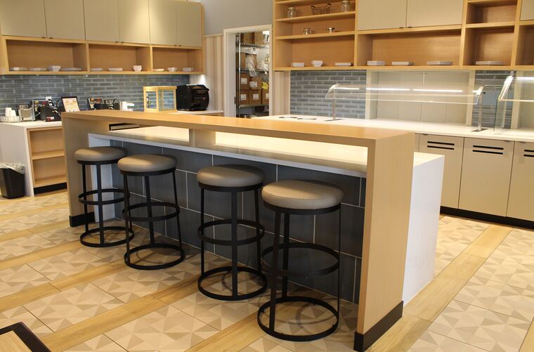 Market island with a raised oak bar top and seating