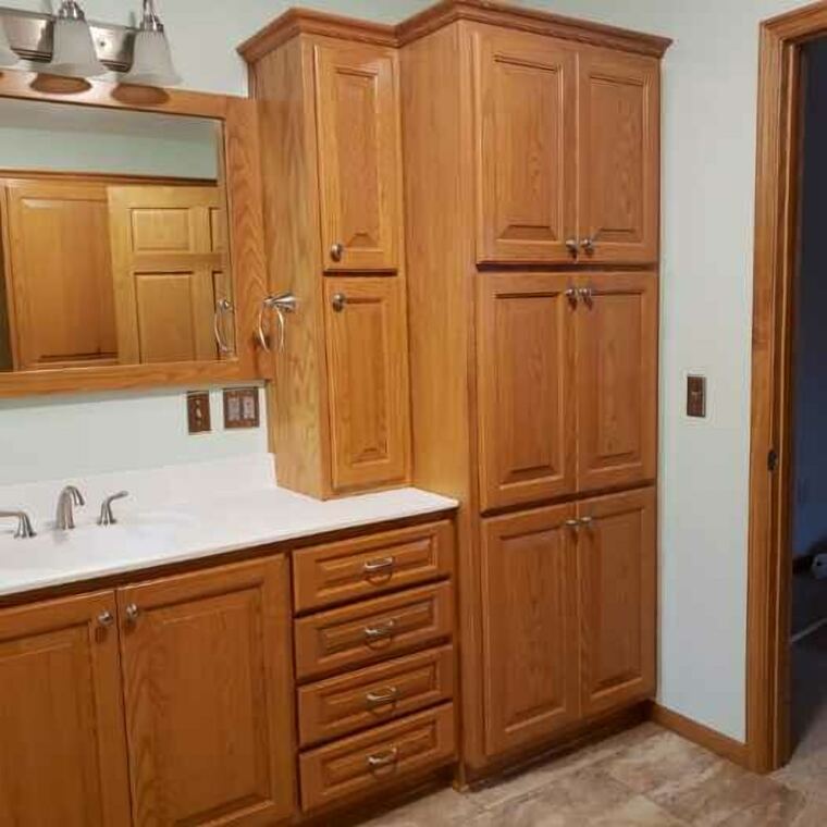 Oak bathroom vanity with a full-height linen tower