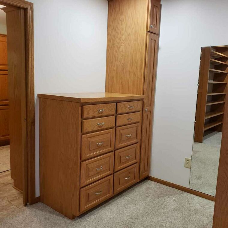 Oak bedroom dresser built in beside a closet