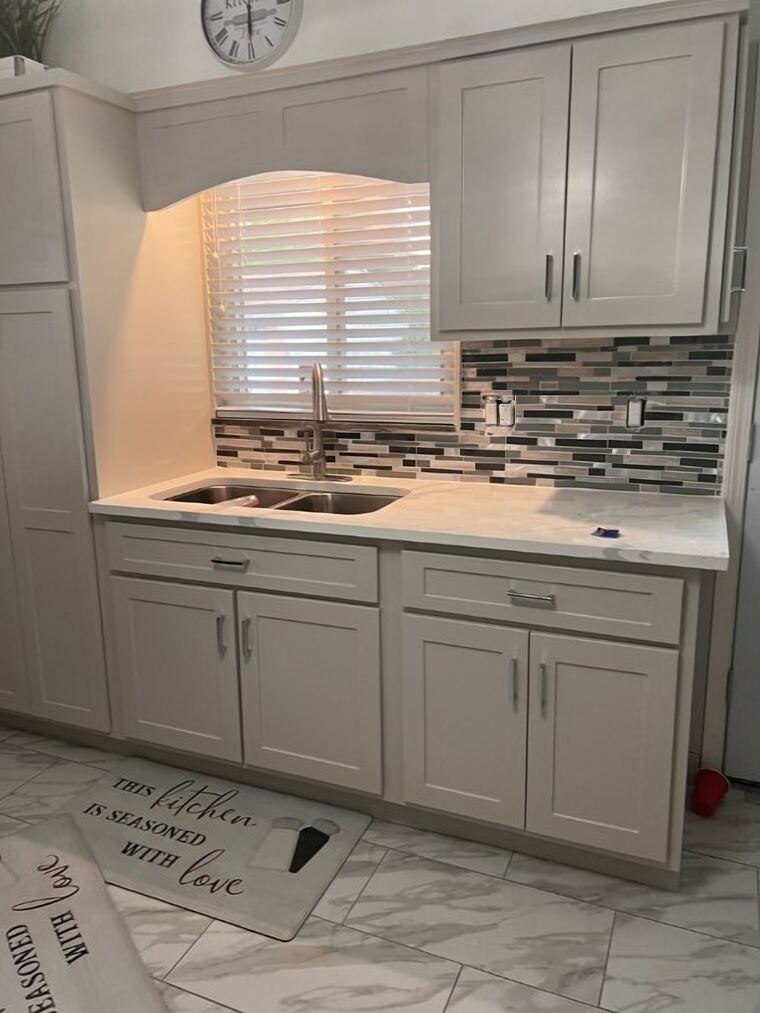 Painted kitchen with an arched valance over the sink window