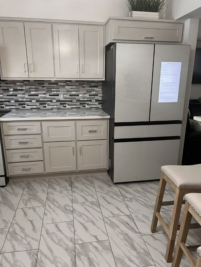 Painted kitchen with a full-height cabinet and overhead bridge cabinet