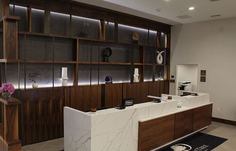 Reception desk with lit display shelving