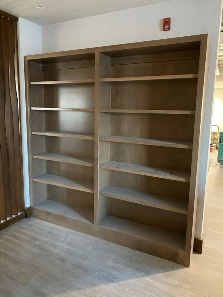 Stained double bookcase built into a finished wall