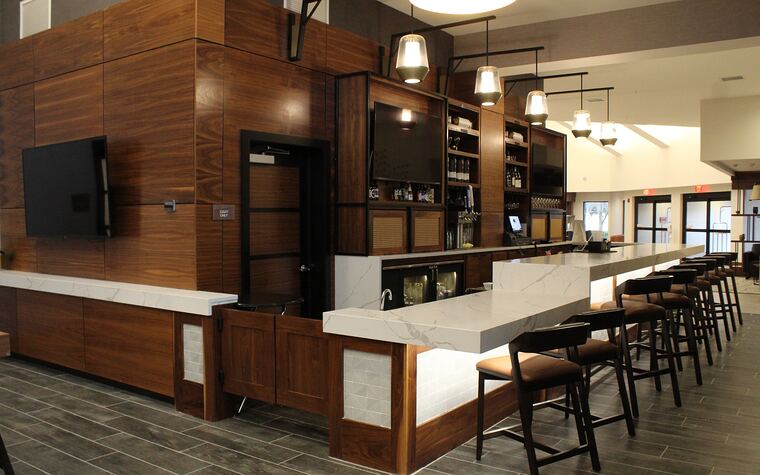 Walnut bar with waterfall countertop