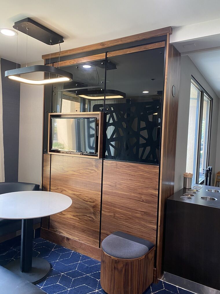 Walnut partition with a laser-cut panel and glass surround