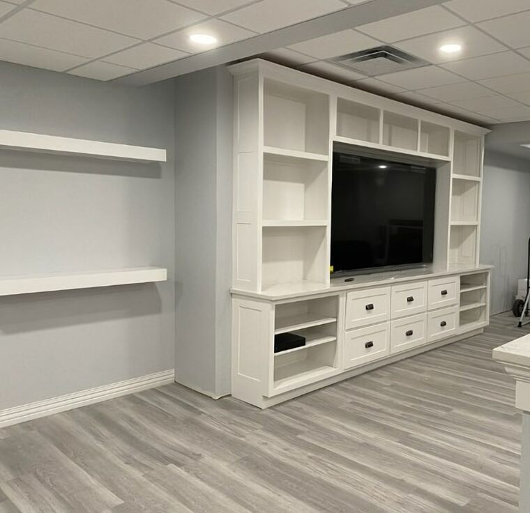White entertainment center built in with open shelving and drawers