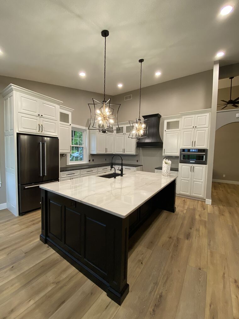 White kitchen with dark island and marble top