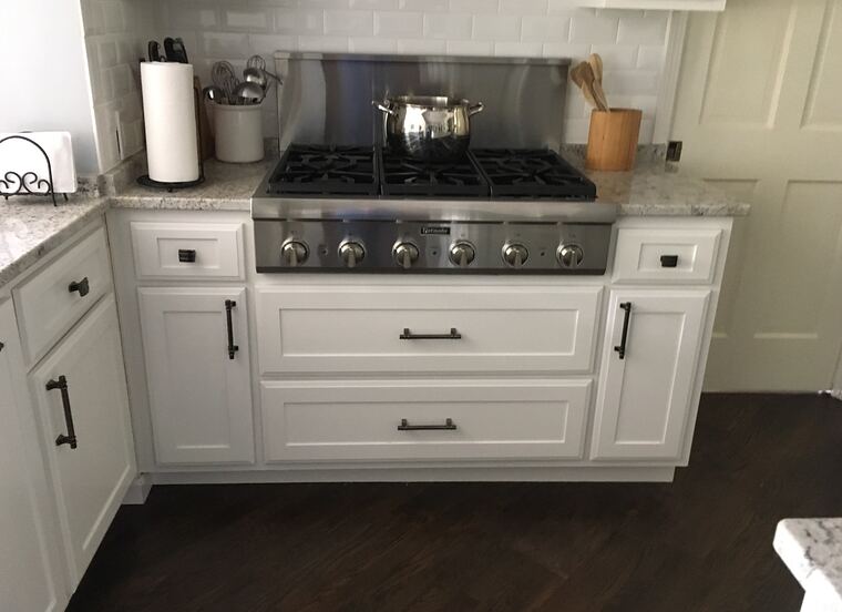 White kitchen base cabinets with deep drawers and a granite top