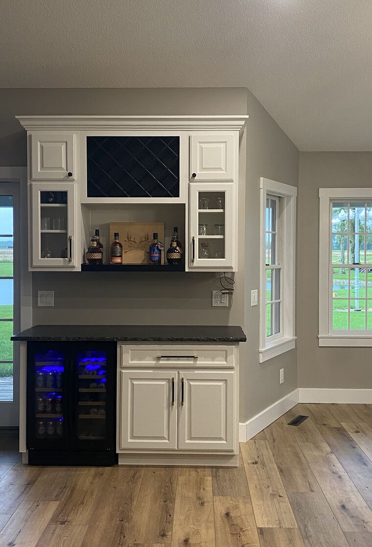 White kitchen with wine bar and glass-front cabinets